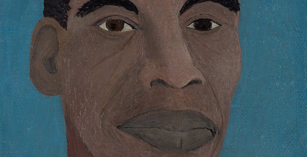 A Self-Portrait painting by the African American Painter Horace Pippin. A Black man sits against a blue background from his shoulders up looking directly towards us with deep brown eyes. He is wearing a black suit, off-white yellowish suit, and a striped tie with brown and a golden-mustard yellow. 