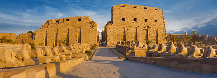 View of the Karnak Temple full of light behind a bright blue sky 